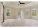 Bedroom with tray ceiling, fan and multiple windows that provide natural lighting at 100 Percheron Dr, Canton, GA 30114