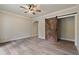 Bedroom with light walls, new flooring, a ceiling fan, and an open sliding barn door at 100 Percheron Dr, Canton, GA 30114