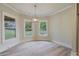 Bright dining area with neutral paint, pendant lighting, and backyard views through several windows at 100 Percheron Dr, Canton, GA 30114
