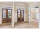 Bright foyer with a view of the front yard features paneling and hardwood floors at 100 Percheron Dr, Canton, GA 30114