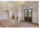 Inviting foyer with decorative lighting, hardwood floors, and neutral wall color at 100 Percheron Dr, Canton, GA 30114