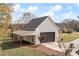 Detached two-car garage with an attached carport and mature trees in the background at 100 Percheron Dr, Canton, GA 30114