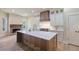Modern kitchen with a large island, stone fireplace, stainless steel appliances, and custom cabinetry at 100 Percheron Dr, Canton, GA 30114
