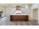 Open-concept kitchen boasts a spacious island, custom hood, and seamless flow to living spaces at 100 Percheron Dr, Canton, GA 30114
