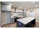 Bright kitchen featuring gray cabinets, stainless hood, large island, and modern shelving at 100 Percheron Dr, Canton, GA 30114