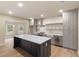 Gourmet kitchen with gray cabinetry, stainless appliances, large island, and modern pendant lighting at 100 Percheron Dr, Canton, GA 30114