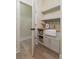 Charming laundry room featuring lower cabinets, wooden countertop and open shelving at 100 Percheron Dr, Canton, GA 30114