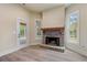 Cozy living room with a stone fireplace, natural light, and access to an outdoor deck at 100 Percheron Dr, Canton, GA 30114