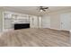Open-concept living room flows to kitchen featuring wood floors, and neutral colors throughout at 100 Percheron Dr, Canton, GA 30114