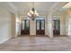 Bright living room featuring double doors, chandelier, and beautiful hardwood flooring at 100 Percheron Dr, Canton, GA 30114