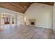 Spacious living room with vaulted wood ceiling, elegant stone fireplace and double door entry at 100 Percheron Dr, Canton, GA 30114
