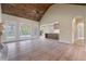 Spacious living room with vaulted wood ceiling, fireplace, and seamless flow to the kitchen at 100 Percheron Dr, Canton, GA 30114