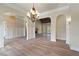 Bright living room featuring fireplace, arched doorways, chandelier, and beautiful hardwood flooring at 100 Percheron Dr, Canton, GA 30114