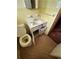 Compact bathroom featuring a toilet, sink, and storage at 6380 Mableton Sw Pkwy, Mableton, GA 30126