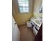 Compact bathroom featuring a toilet, sink, and storage at 6380 Mableton Sw Pkwy, Mableton, GA 30126