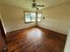 Bedroom featuring hardwood floors, a ceiling fan, and natural light from a window, awaiting personalization at 6380 Mableton Sw Pkwy, Mableton, GA 30126