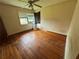 Bedroom featuring hardwood floors, a ceiling fan, and natural light from a window, ideal for relaxation at 6380 Mableton Sw Pkwy, Mableton, GA 30126