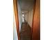 Long hallway showcasing the home's layout and flow with hardwood flooring and some deferred maintenance at 6380 Mableton Sw Pkwy, Mableton, GA 30126