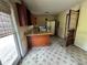 Functional kitchen featuring a breakfast bar, tiled floor, and access to the backyard at 6380 Mableton Sw Pkwy, Mableton, GA 30126