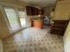 Functional kitchen featuring a breakfast bar, tiled floor, and access to the backyard at 6380 Mableton Sw Pkwy, Mableton, GA 30126