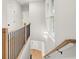 Hallway featuring a wooden and black railing, white walls, and a large window allowing natural light at 1697 Thomas St, Decatur, GA 30032