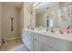 Bathroom with white vanity and large mirror at 1765 Pinetree Pass Lane Southwest Sw Ln, Lilburn, GA 30047