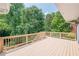 Spacious deck area with wood railings and view of the mature tree line beyond at 1765 Pinetree Pass Lane Southwest Sw Ln, Lilburn, GA 30047