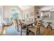 Open dining area features a rustic wood table and a large arched window with natural light, leading to the adjacent kitchen at 1765 Pinetree Pass Lane Southwest Sw Ln, Lilburn, GA 30047