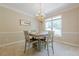 Charming dining room with a chandelier, a square table, and bright natural light at 1765 Pinetree Pass Lane Southwest Sw Ln, Lilburn, GA 30047