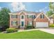 Beautiful two-story brick home with well-manicured lawn and attached two car garage at 1765 Pinetree Pass Lane Southwest Sw Ln, Lilburn, GA 30047