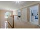 Bright hallway with white railing offering views to the rooms and foyer below at 1765 Pinetree Pass Lane Southwest Sw Ln, Lilburn, GA 30047