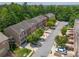 Overhead view of a community featuring brick townhomes with driveways and verdant landscaping at 2264 Ewell Park Dr, Lawrenceville, GA 30043