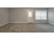 Unfinished basement with neutral walls, carpet, and exterior access door at 2264 Ewell Park Dr, Lawrenceville, GA 30043