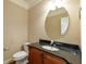 Elegant half-bathroom with granite countertops and a decorative mirror at 2264 Ewell Park Dr, Lawrenceville, GA 30043
