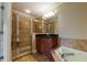 Bathroom featuring a glass enclosed shower and jacuzzi tub at 2264 Ewell Park Dr, Lawrenceville, GA 30043