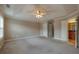 Spacious bedroom with a trey ceiling and ceiling fan with carpeted floors and neutral paint at 2264 Ewell Park Dr, Lawrenceville, GA 30043