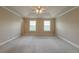 The spacious bedroom features plush carpeting, neutral paint, and a tray ceiling at 2264 Ewell Park Dr, Lawrenceville, GA 30043
