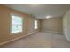 Bright bedroom with carpeted floors and natural light from two windows, creating a comfortable atmosphere at 2264 Ewell Park Dr, Lawrenceville, GA 30043