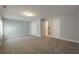 Empty bonus room with carpet, light blue walls, and multiple doors at 2264 Ewell Park Dr, Lawrenceville, GA 30043