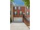 Charming brick townhome with a two-car garage, black shutters, and a well-maintained brick stair entry at 2264 Ewell Park Dr, Lawrenceville, GA 30043