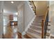 Welcoming foyer featuring hardwood floors and staircase with access to the kitchen at 2264 Ewell Park Dr, Lawrenceville, GA 30043