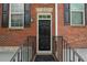 Brick townhome exterior featuring a black front door with black shutters and railing at 2264 Ewell Park Dr, Lawrenceville, GA 30043