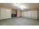 Two car garage with neutral walls, concrete flooring, and automatic garage door at 2264 Ewell Park Dr, Lawrenceville, GA 30043