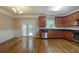 Open-concept kitchen with stainless steel appliances and rich hardwood floors at 2264 Ewell Park Dr, Lawrenceville, GA 30043