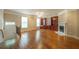 Elegant living room featuring hardwood floors, built-in bookshelves, and a charming fireplace at 2264 Ewell Park Dr, Lawrenceville, GA 30043