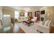 Inviting living room with hardwood floors, a cozy fireplace, built-in bookshelves, and abundant natural light at 2264 Ewell Park Dr, Lawrenceville, GA 30043