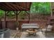 Private patio with stone pavers, privacy fence, covered seating area, and wooded views at 2264 Ewell Park Dr, Lawrenceville, GA 30043