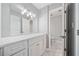 Elegant bathroom featuring a marble countertop, modern lighting fixtures, and a sleek, clean design at 23307 Plantation Ne Dr, Atlanta, GA 30324