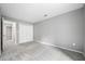 Spacious bedroom with neutral gray walls and carpet, featuring a double door closet and a view of the walk-in closet at 23307 Plantation Ne Dr, Atlanta, GA 30324