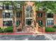 Charming brick condo building with a large arched window above the double door entryway and manicured landscaping at 23307 Plantation Ne Dr, Atlanta, GA 30324